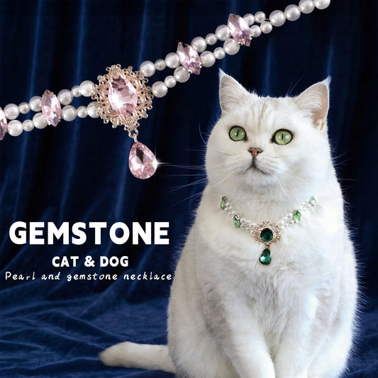 White cat wearing green pearl and gem pendant pet necklace