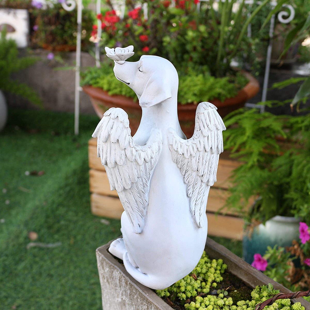 Back view showing detailed angel wings on dog memorial statue