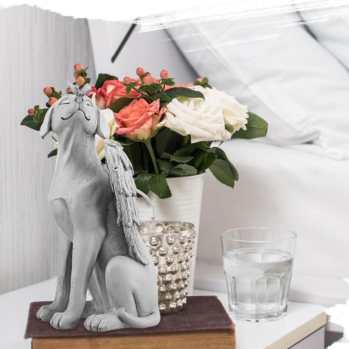 Winged dog remembrance statue styled indoors with flowers