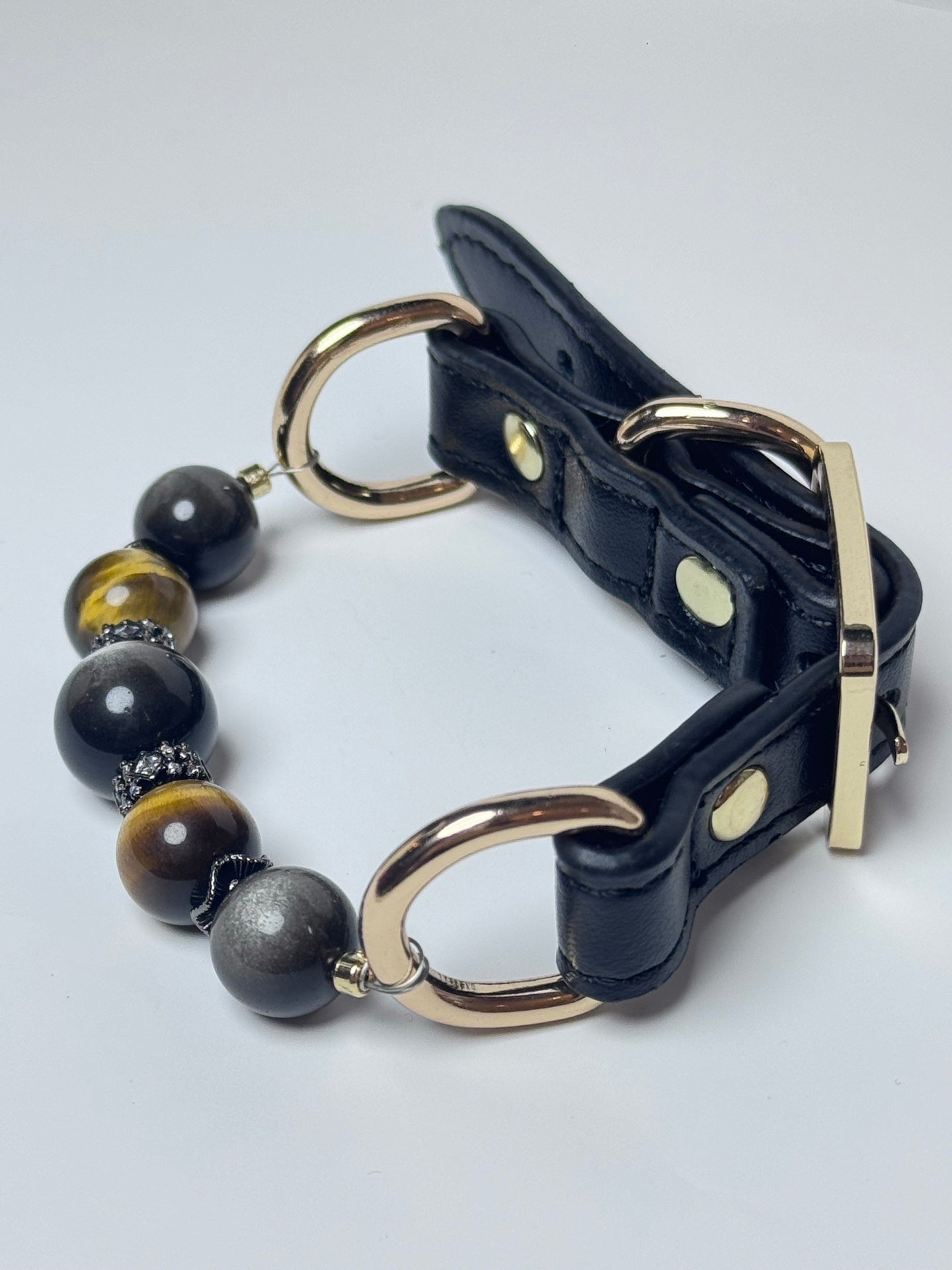 Black leather pet collar with polished gold-tone buckle and hardware