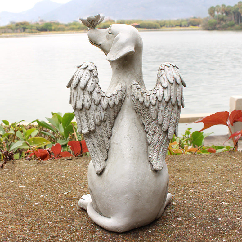 Rear view of feathered wings on angel dog memorial sculpture
