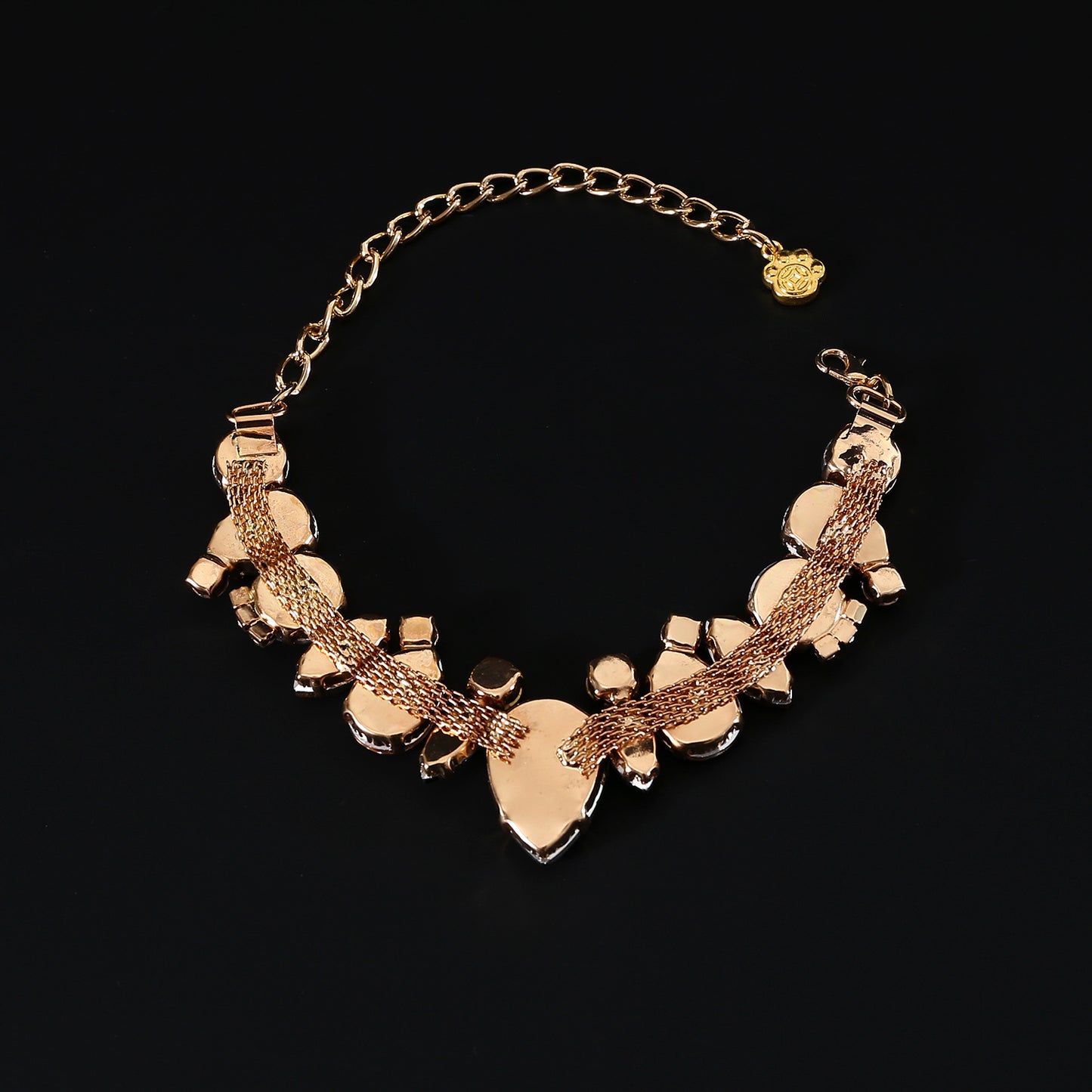 Gold-tone backing and extension chain detail