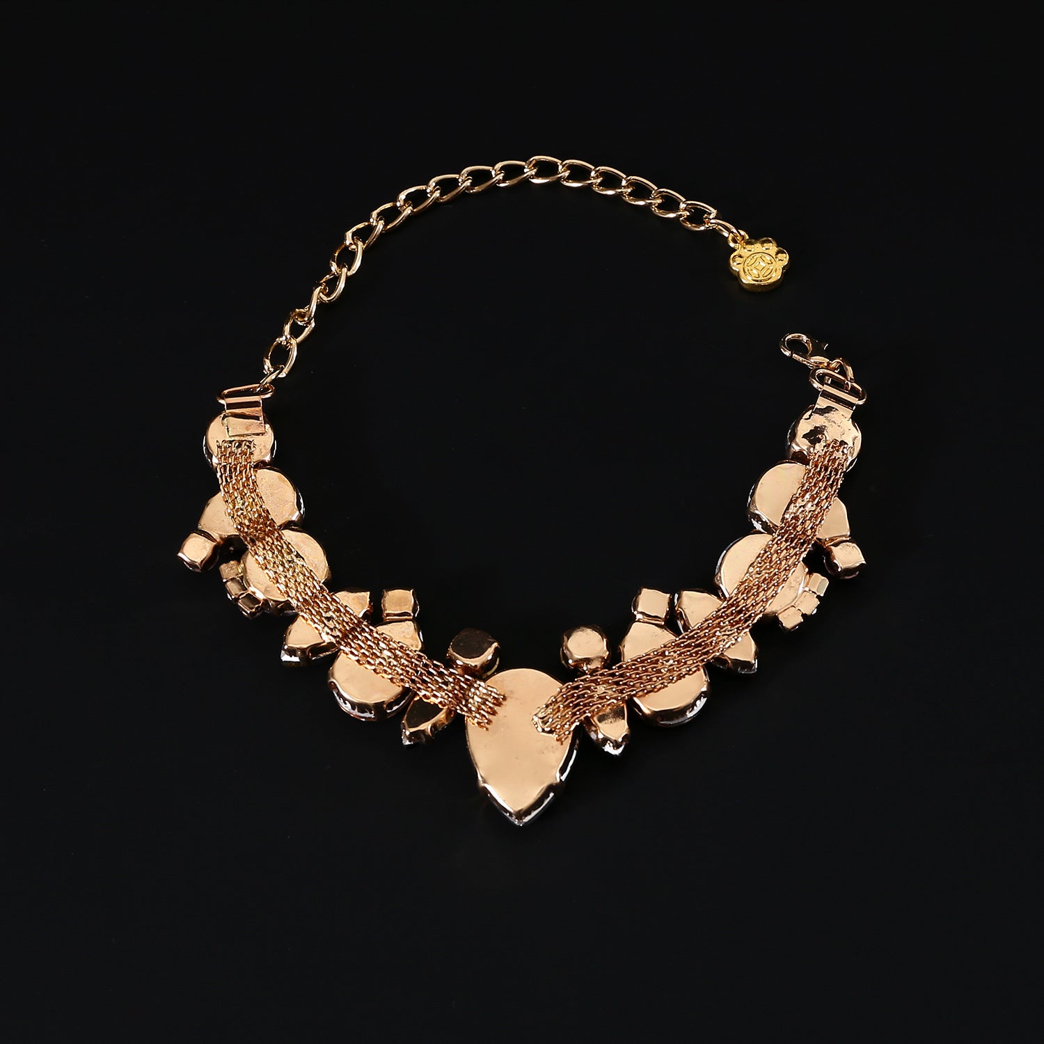 Gold-tone backing and extension chain detail