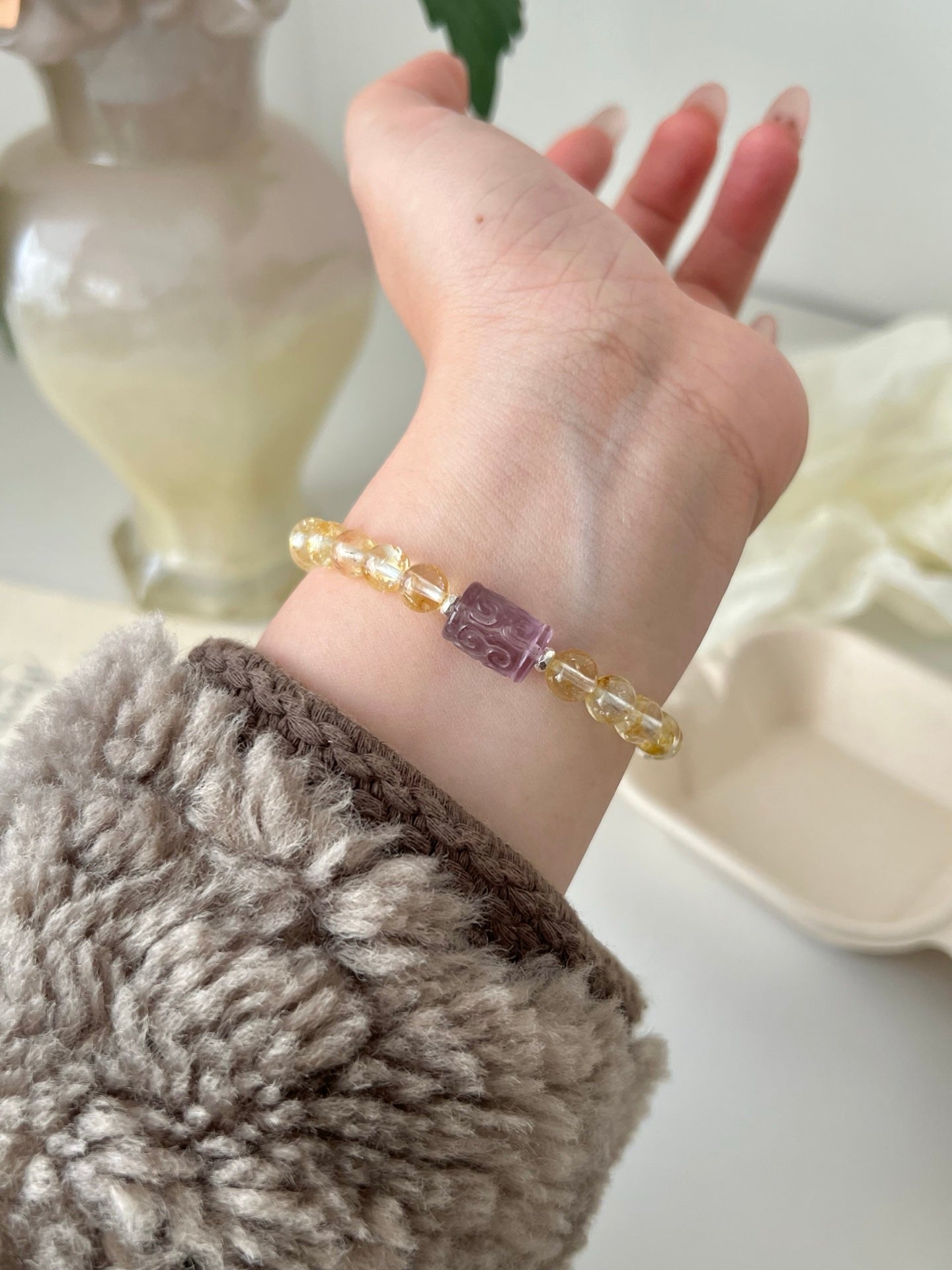 Purple patterned barrel bead bracelet worn on wrist